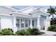 Classic design with crisp white trim, a durable metal roof, and lush green landscaping at 2508 Belvoir Blvd, Sarasota, FL 34237