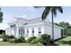 Side view of a white home with a metal roof, complemented by well-maintained landscaping at 2508 Belvoir Blvd, Sarasota, FL 34237