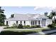 Charming single story home featuring a modern design with a light gray metal roof and lush tropical landscaping at 2508 Belvoir Blvd, Sarasota, FL 34237