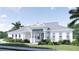 Striking home with a gray metal roof, white exterior, and covered porch perfect curb appeal at 2508 Belvoir Blvd, Sarasota, FL 34237