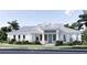 Beautiful single story home boasting a stylish light gray metal roof and inviting front entry with a blue door at 2508 Belvoir Blvd, Sarasota, FL 34237