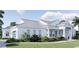 Stunning exterior view of a home featuring a metal roof, light blue door, and lush landscaping at 2508 Belvoir Blvd, Sarasota, FL 34237