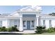 Charming front entrance with stately columns and beautiful landscaping at 2508 Belvoir Blvd, Sarasota, FL 34237