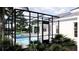 Screened pool area featuring outdoor seating, and lush greenery providing privacy at 2508 Belvoir Blvd, Sarasota, FL 34237