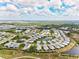 Stunning aerial view of a Primary-planned community with beautiful landscaping, lakes, and modern homes at 2894 Butterfly Jasmine Trl, Sarasota, FL 34240