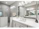Elegant bathroom featuring a spacious walk-in shower, double sink vanity, and ample lighting, perfect for a spa-like experience at 2894 Butterfly Jasmine Trl, Sarasota, FL 34240
