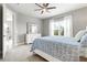 Spacious bedroom filled with natural light featuring a ceiling fan, dresser, and a comfortable bed, perfect for relaxation at 2894 Butterfly Jasmine Trl, Sarasota, FL 34240