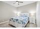 Inviting bedroom with a comfortable bed, side tables, and a ceiling fan, creating a relaxing and cozy atmosphere at 2894 Butterfly Jasmine Trl, Sarasota, FL 34240