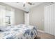 Bright bedroom with a ceiling fan, large window, and a cozy bed, creating a comfortable and inviting space at 2894 Butterfly Jasmine Trl, Sarasota, FL 34240