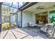 Outdoor patio area with sliding glass doors and a view of the lush landscaping at 2894 Butterfly Jasmine Trl, Sarasota, FL 34240