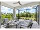Relaxing outdoor patio with a screened-in enclosure and a view of the lush greenery at 2894 Butterfly Jasmine Trl, Sarasota, FL 34240