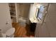 Bathroom with a modern sink and mirror, tiled shower, and wooden storage shelves at 33 Tee View Pl, Rotonda West, FL 33947