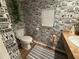 Toilet area featuring newspaper-themed wallpaper and hardwood floors at 33 Tee View Pl, Rotonda West, FL 33947