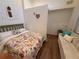 Cozy bedroom with a floral comforter and a seating nook at 33 Tee View Pl, Rotonda West, FL 33947
