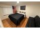 Cozy bedroom with wood floors, large window and American flag decoration at 33 Tee View Pl, Rotonda West, FL 33947