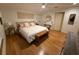 Inviting bedroom with a bed, a makeup vanity, and wood floors at 33 Tee View Pl, Rotonda West, FL 33947