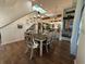 Bright dining room with hardwood floors, modern chandelier, and seamlessly connects to the kitchen space at 33 Tee View Pl, Rotonda West, FL 33947