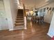Inviting dining area with hardwood floors, open staircase, and a view into the modern kitchen at 33 Tee View Pl, Rotonda West, FL 33947