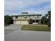 Charming two-story home with a metal roof, landscaped yard, and a spacious two-car garage at 33 Tee View Pl, Rotonda West, FL 33947
