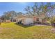Charming backyard featuring a patio area, garage, and well-maintained lawn at 3883 Tampico Dr, Sarasota, FL 34235