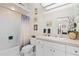 Bright bathroom featuring a shower-tub combo with white tile and vanity sink at 3883 Tampico Dr, Sarasota, FL 34235