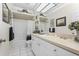 Clean, bright bathroom featuring a shower-tub combo with white tile and vanity sink at 3883 Tampico Dr, Sarasota, FL 34235