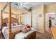 Bedroom featuring a four-poster bed, ceiling fan and closet with sliding doors at 3883 Tampico Dr, Sarasota, FL 34235