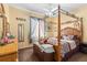Cozy bedroom with a four-poster bed, soft carpet, and natural light from the windows at 3883 Tampico Dr, Sarasota, FL 34235