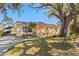 Charming single-story home featuring a well-manicured lawn and a mature shade tree at 3883 Tampico Dr, Sarasota, FL 34235