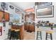 Custom Garage bar area featuring stools and overhead lighting with assorted decorations at 3883 Tampico Dr, Sarasota, FL 34235
