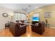 Comfortable living room boasts hardwood floors, vaulted ceilings, and ample natural light at 3883 Tampico Dr, Sarasota, FL 34235