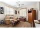 Comfortable living room area with soft carpet, sofa, cabinet and natural light from the windows at 3883 Tampico Dr, Sarasota, FL 34235