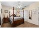 Comfortable main bedroom featuring a four-poster bed, soft carpet, and a ceiling fan at 3883 Tampico Dr, Sarasota, FL 34235
