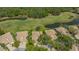 Aerial view showcases a neighborhood with golf course and multiple ponds amidst lush greenery and mature trees at 3950 Oakley Greene # 36, Sarasota, FL 34235
