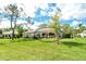 Scenic backyard with lush green grass and beautiful landscaping, ideal for relaxation at 3950 Oakley Greene # 36, Sarasota, FL 34235
