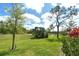 Beautiful backyard featuring verdant landscape and mature trees with distant water views at 3950 Oakley Greene # 36, Sarasota, FL 34235