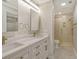 Updated bathroom with double sinks, quartz countertops, modern lighting, and walk-in shower at 3950 Oakley Greene # 36, Sarasota, FL 34235