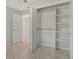 Bedroom closet with white shelving and hanging rods at 3950 Oakley Greene # 36, Sarasota, FL 34235