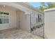 Private front courtyard featuring brick pavers and a decorative security gate at 3950 Oakley Greene # 36, Sarasota, FL 34235