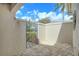 Private front courtyard with brick pavers and an ornate entry gate at 3950 Oakley Greene # 36, Sarasota, FL 34235