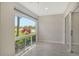 Tiled Florida room with large arched windows offering views of the lush green outdoor space at 3950 Oakley Greene # 36, Sarasota, FL 34235