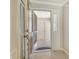 Bright foyer showcasing tiled floors, a glass front door, and a coat closet at 3950 Oakley Greene # 36, Sarasota, FL 34235