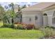 Charming exterior featuring lush landscaping and elegant front gate access at 3950 Oakley Greene # 36, Sarasota, FL 34235