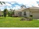 Charming single-story home featuring lush landscaping and elegant exterior details at 3950 Oakley Greene # 36, Sarasota, FL 34235