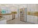 Spacious kitchen features stainless steel appliances, granite countertops, and white cabinets at 3950 Oakley Greene # 36, Sarasota, FL 34235