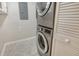 Modern laundry area equipped with stacked washer and dryer, and ample storage at 3950 Oakley Greene # 36, Sarasota, FL 34235