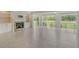 Spacious living room featuring a fireplace, built-in shelving, and large windows with outdoor views at 3950 Oakley Greene # 36, Sarasota, FL 34235