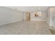 Bright, open-plan living room with tile flooring and views into the adjacent kitchen area at 3950 Oakley Greene # 36, Sarasota, FL 34235