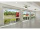 Bright living room featuring tile floors, ceiling fans, and expansive windows overlooking the yard at 3950 Oakley Greene # 36, Sarasota, FL 34235