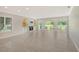 Bright living room featuring tile floors, built-in shelving, and large windows with a view at 3950 Oakley Greene # 36, Sarasota, FL 34235